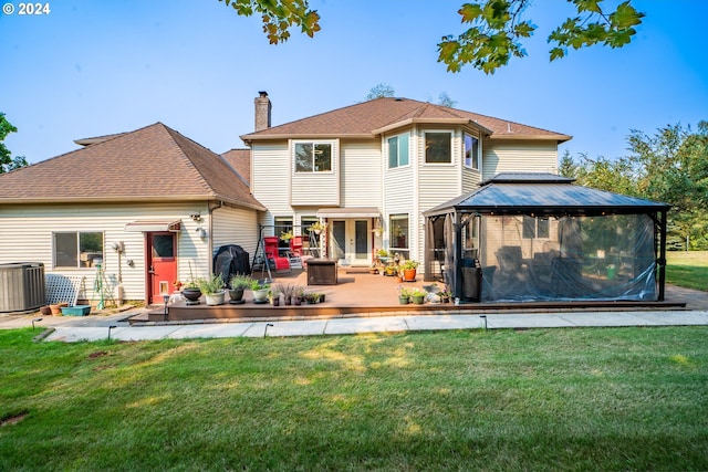 rear view of house with a patio, a chimney, central air condition unit, a lawn, and a gazebo