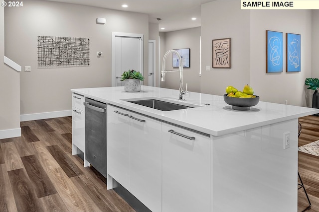 kitchen with white cabinetry, sink, dark hardwood / wood-style floors, and a kitchen island with sink