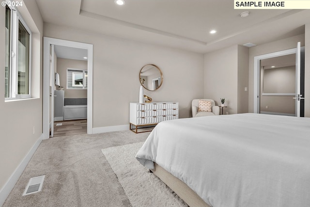 bedroom featuring carpet and ensuite bath