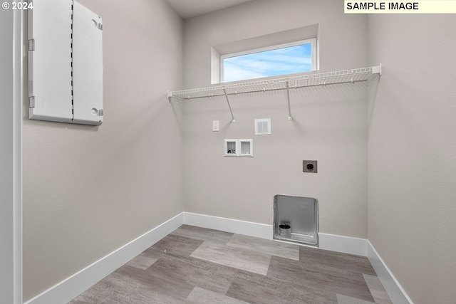 laundry area with light hardwood / wood-style floors, hookup for a washing machine, and electric dryer hookup