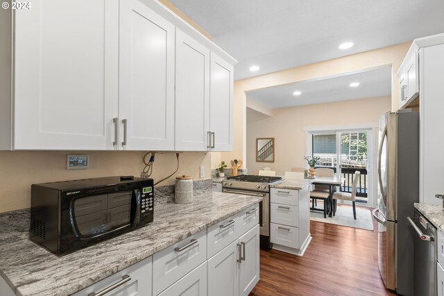 kitchen featuring white cabinetry, appliances with stainless steel finishes, and light stone counters