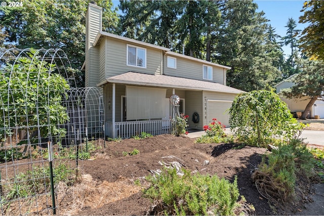 view of property with a garage and covered porch