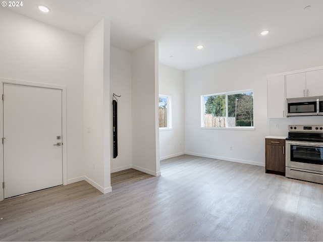 kitchen featuring light hardwood / wood-style floors, white cabinetry, and stainless steel appliances