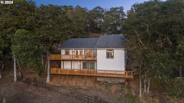 back of property featuring a wooden deck