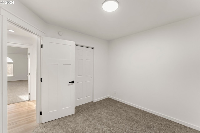 unfurnished bedroom with a closet and carpet flooring