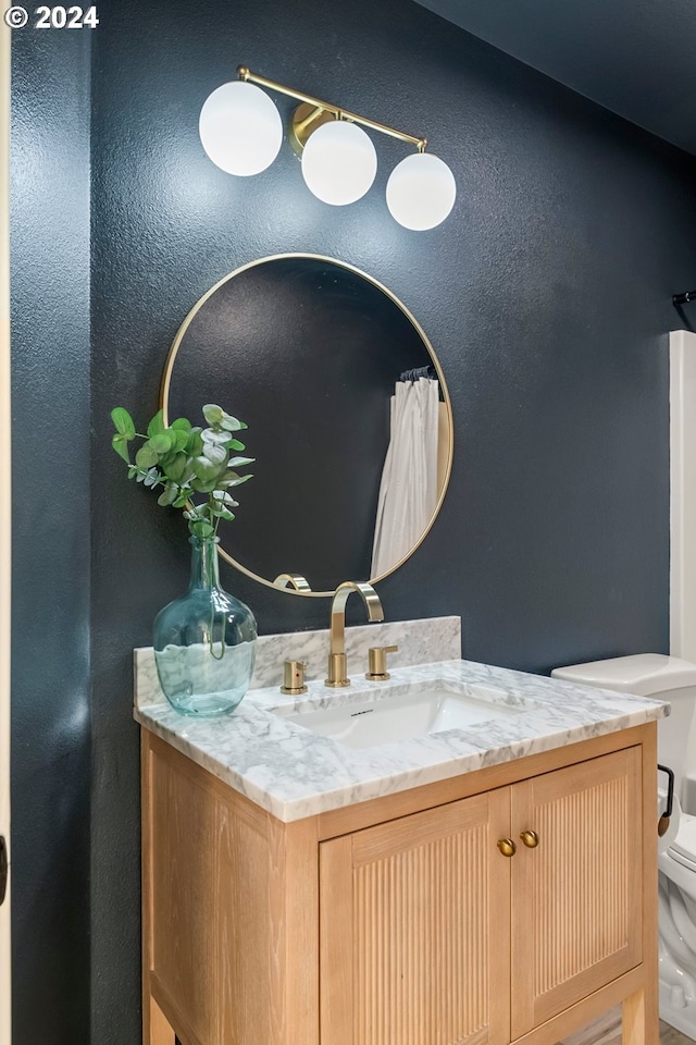 bathroom featuring vanity and toilet