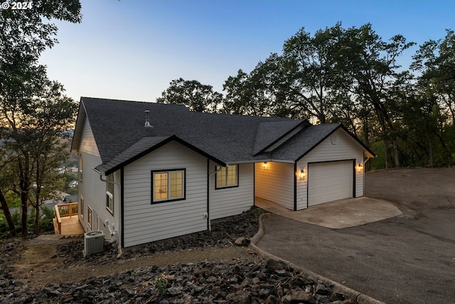 view of front of house with a garage and central AC