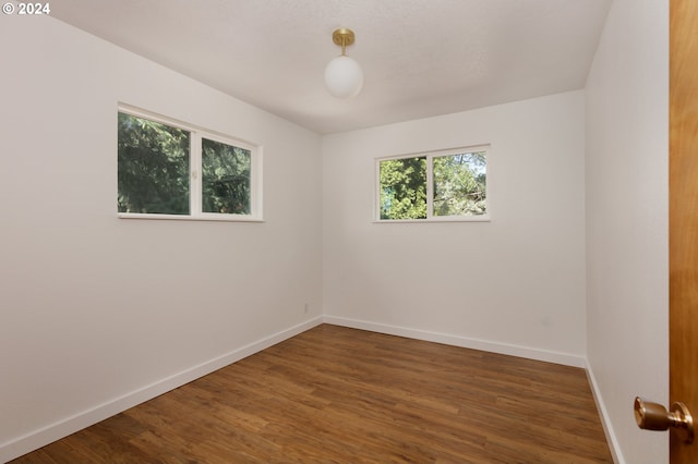 unfurnished room featuring dark hardwood / wood-style floors