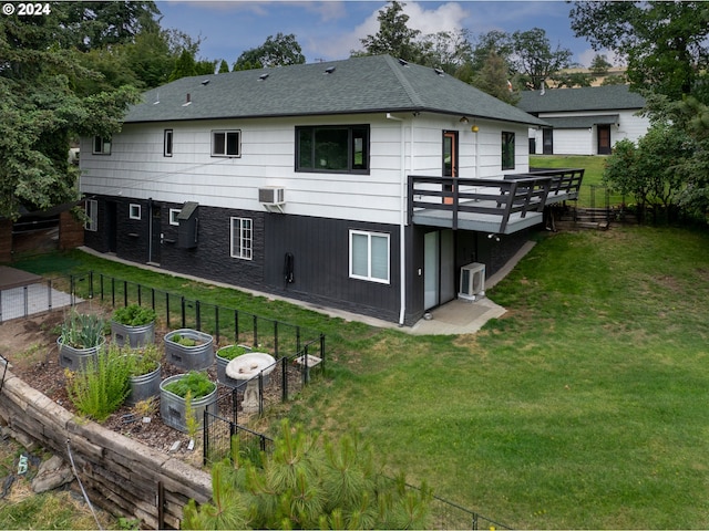 back of house with a wall mounted AC, a yard, and a wooden deck