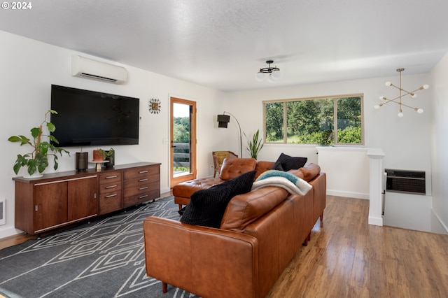 living room with dark wood-type flooring, a wall mounted air conditioner, and plenty of natural light