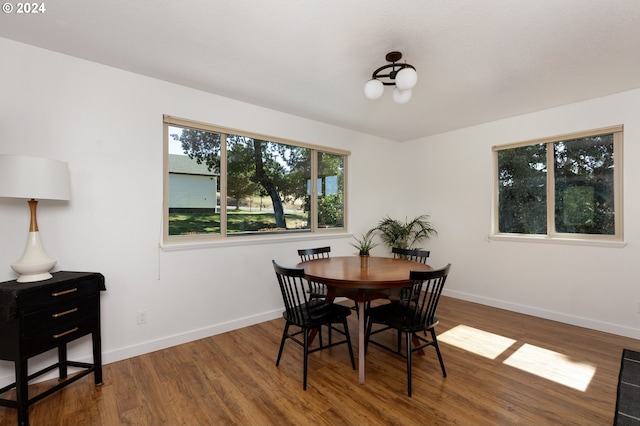 dining space with wood-type flooring