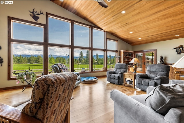 living room featuring high vaulted ceiling, light hardwood / wood-style floors, french doors, ceiling fan, and wood ceiling