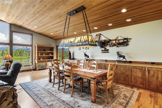 dining area with vaulted ceiling, wood ceiling, light hardwood / wood-style floors, and a wealth of natural light