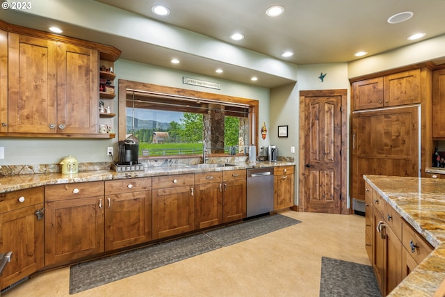 kitchen featuring stainless steel dishwasher, dark carpet, light stone counters, paneled fridge, and sink