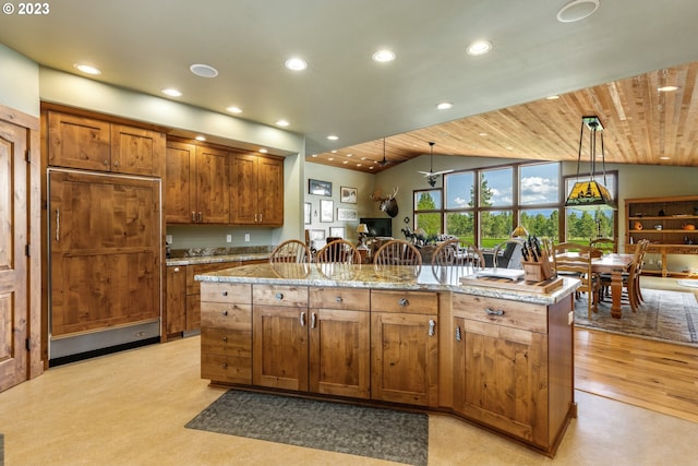 kitchen with decorative light fixtures, light hardwood / wood-style flooring, light stone counters, wooden ceiling, and paneled fridge