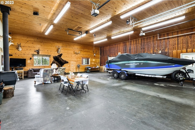 garage with wood walls, a garage door opener, wood ceiling, and a wood stove