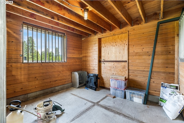 interior space with beamed ceiling and wood walls