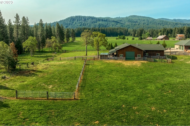 exterior space featuring a yard, a mountain view, and a rural view