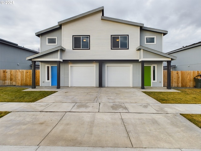 front of property with a front lawn and a garage