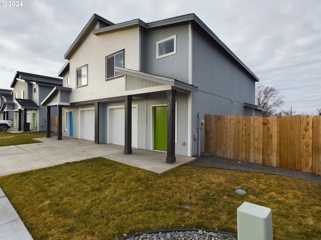 view of front of home featuring a front lawn and a garage