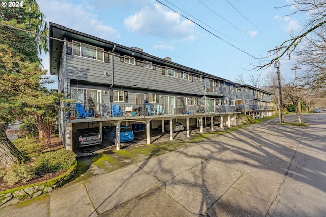 back of house featuring a carport