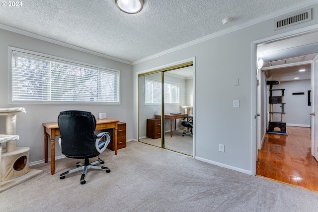 office area featuring crown molding, light hardwood / wood-style flooring, and a textured ceiling