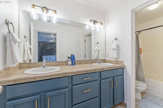 full bathroom with vanity, shower / bath combo, and toilet