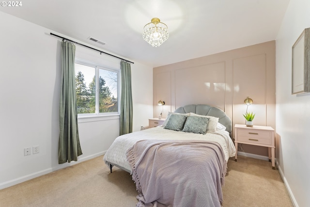 carpeted bedroom with a chandelier