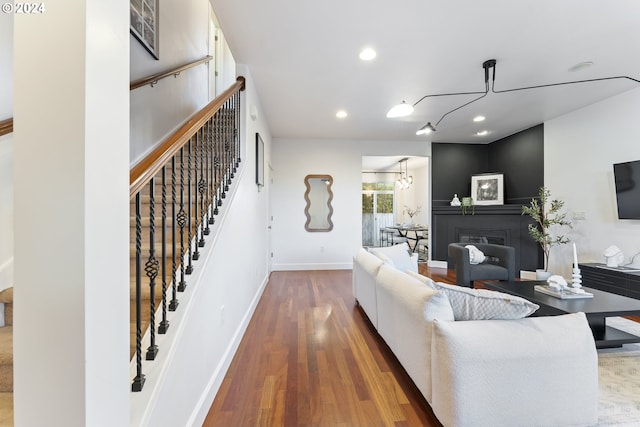 living room with an inviting chandelier and hardwood / wood-style flooring