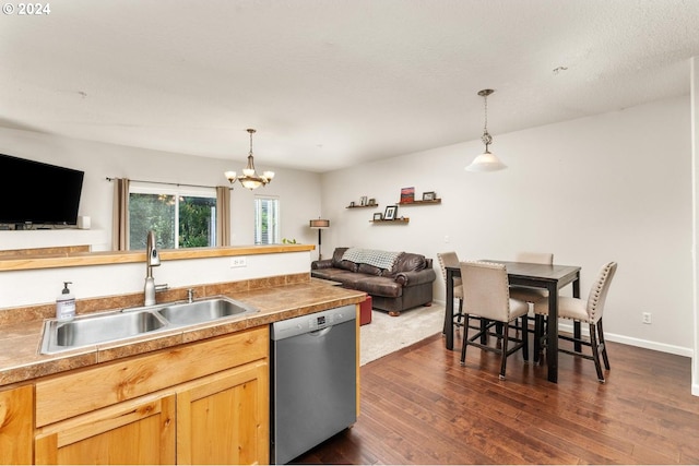 kitchen with hanging light fixtures, dishwasher, dark hardwood / wood-style flooring, a notable chandelier, and sink