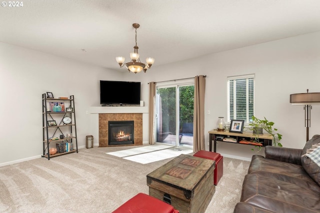 living room with light colored carpet, a notable chandelier, and a tile fireplace