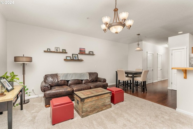 living room with dark hardwood / wood-style floors and an inviting chandelier