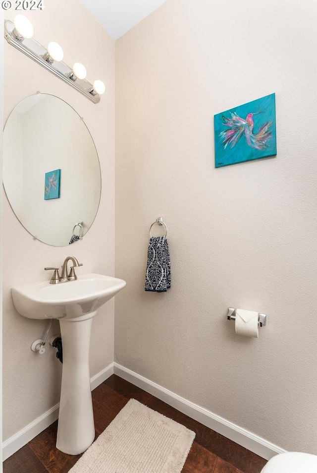 bathroom with hardwood / wood-style floors