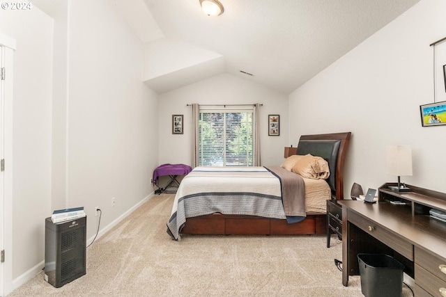 bedroom with light colored carpet and vaulted ceiling