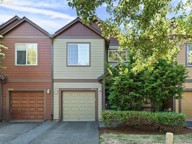 view of property featuring driveway and an attached garage