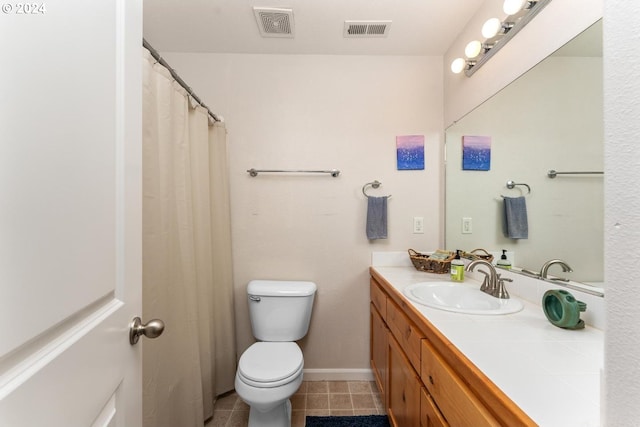 bathroom with vanity, toilet, and tile patterned flooring