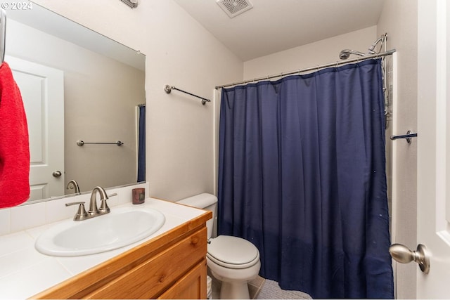 bathroom with vanity, toilet, and walk in shower