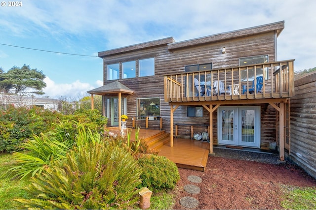 rear view of house with a wooden deck and french doors