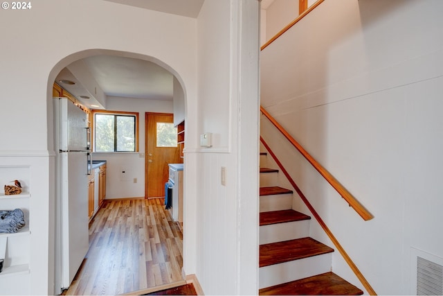 stairs featuring wood-type flooring