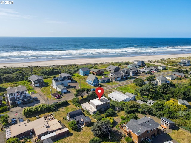 birds eye view of property featuring a water view and a view of the beach