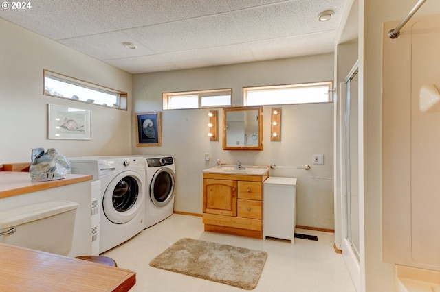 washroom with sink and washer and dryer