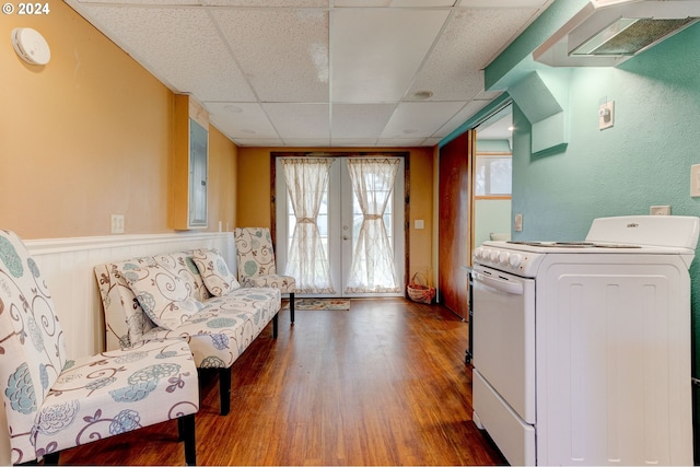 interior space featuring french doors, hardwood / wood-style flooring, and a drop ceiling