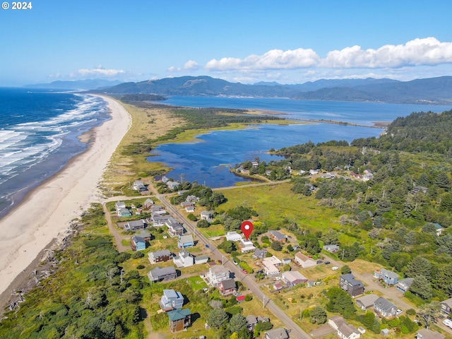 aerial view with a water and mountain view and a beach view