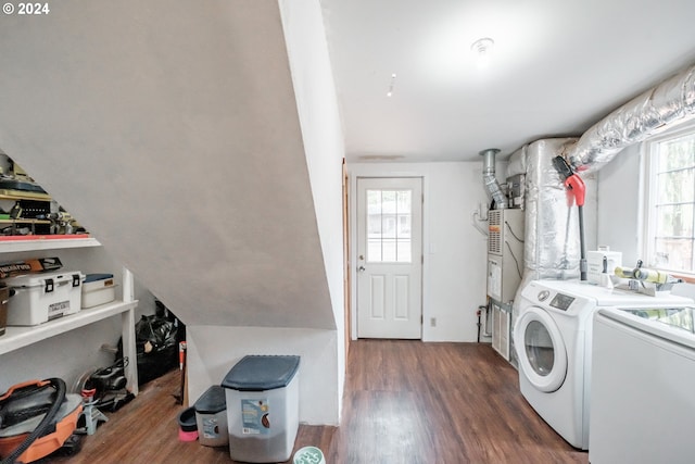 laundry area with laundry area, dark wood finished floors, and washer and dryer