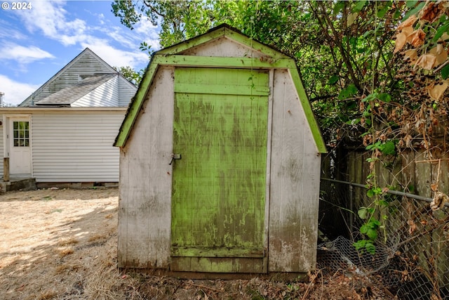 view of shed with fence