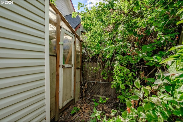 view of outbuilding featuring fence