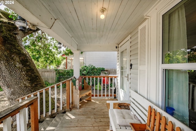 wooden deck with fence and a porch