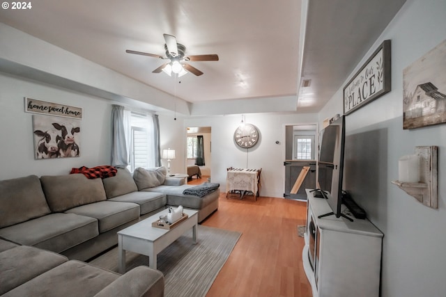 living room featuring light wood-style floors and a ceiling fan