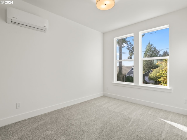 spare room with carpet and a wall mounted air conditioner