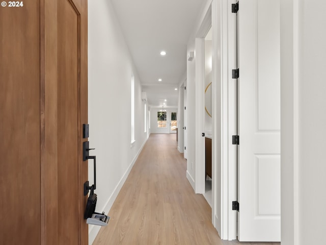 corridor with light hardwood / wood-style floors